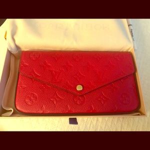 Brand new Louis Vuitton red leather purse in box.